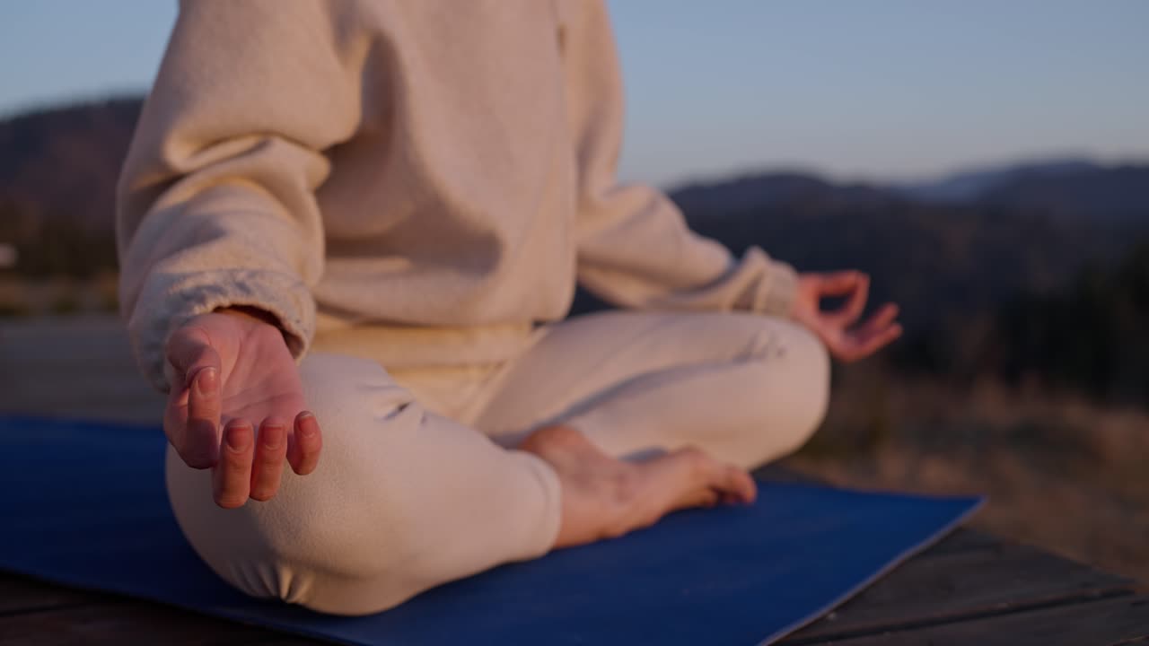 Woman meditating outdoors in a yoga pose
