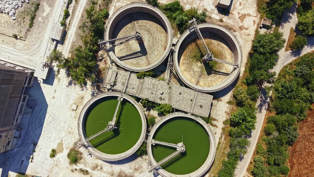 Water treatment facility in a rural area with large round tanks used for processing wastewater