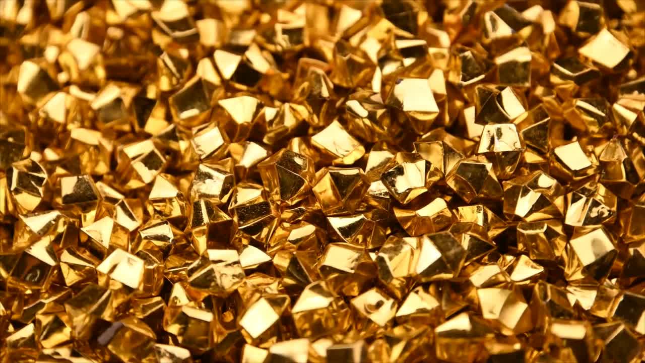 Primo piano di sfondo con forme geometriche dorate scintillanti