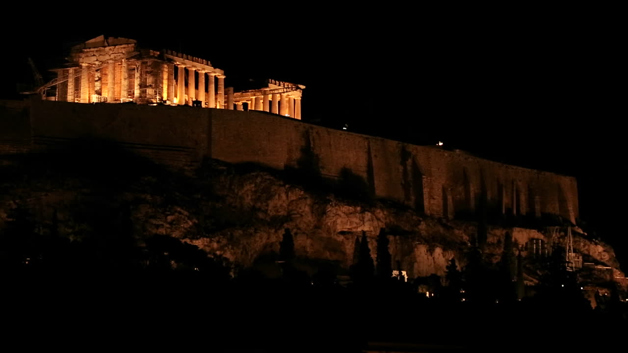 toma nocturna de la acrópolis y el partenón en la cima de una colina en atenas grecia