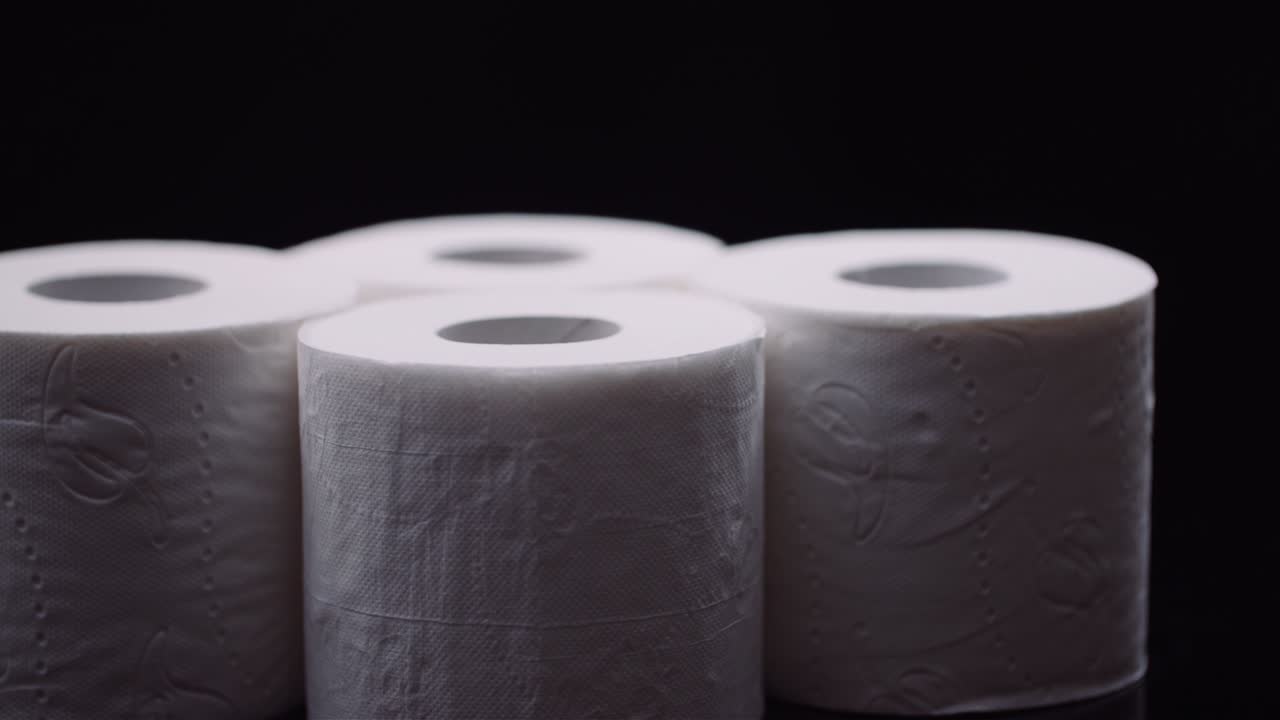 Toilet Paper Isolated on Black Background Rotating.