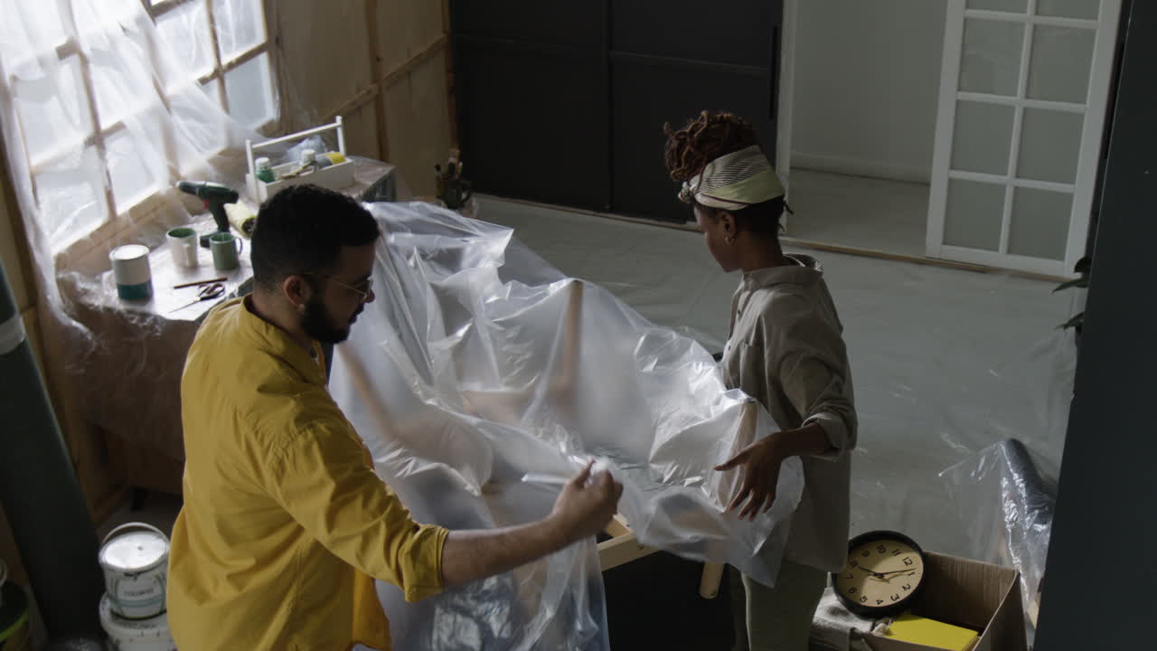 Couple packing furniture for moving