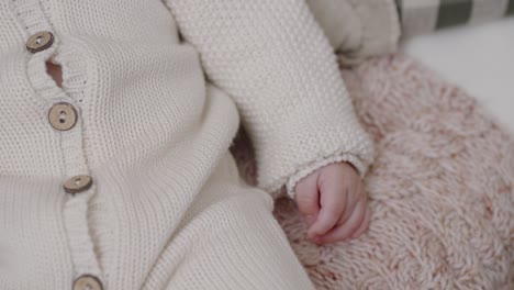 baby's hand in knitted sweater - close-up