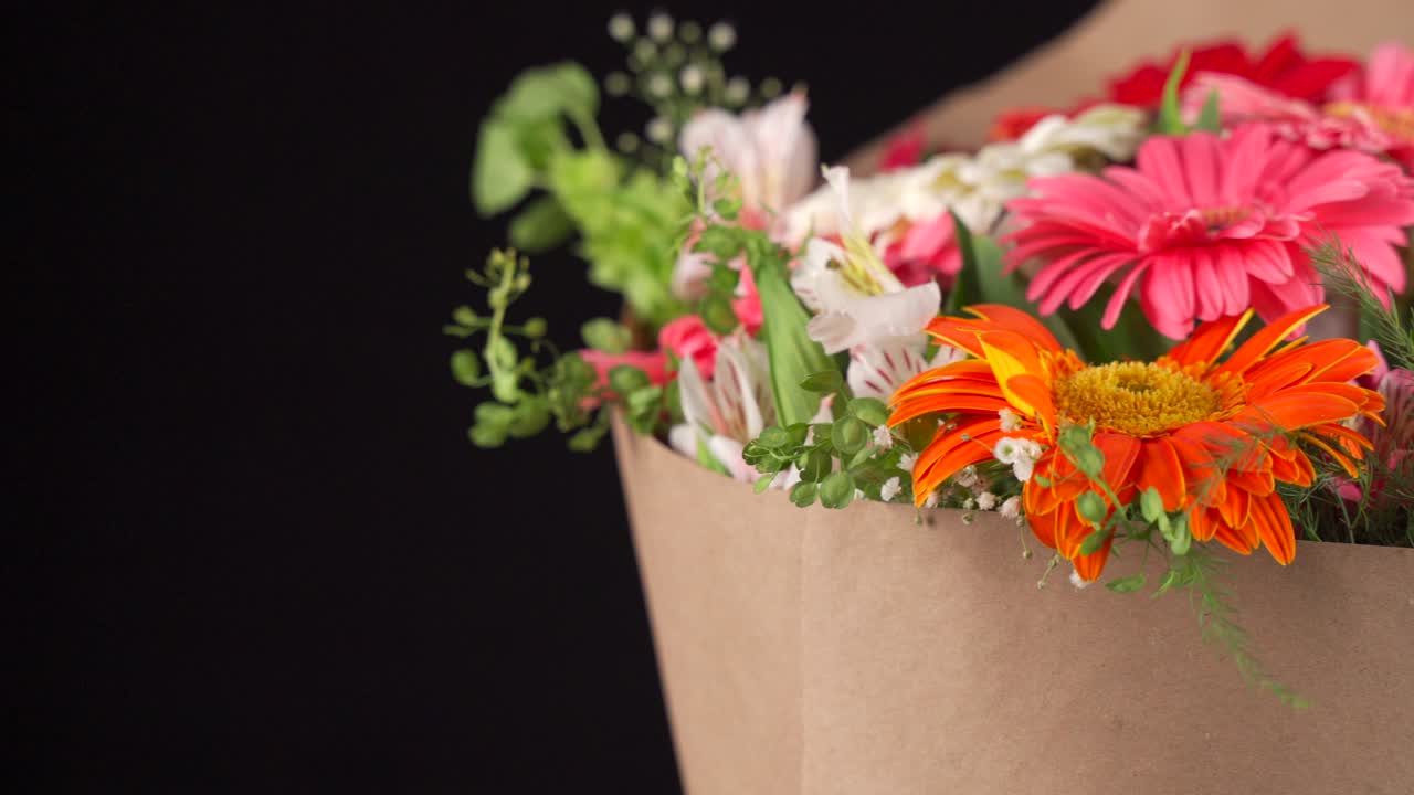 Gerbera and lily flowers arrangement bouquet slider shot black background
