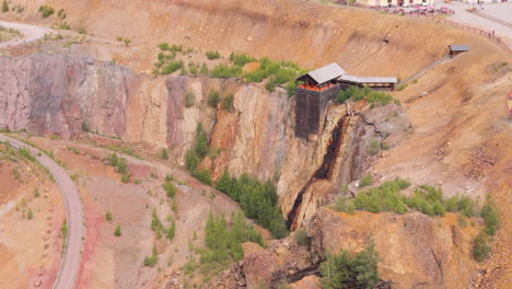 aerial view of an open pit mine with a waterfall and wooden structure