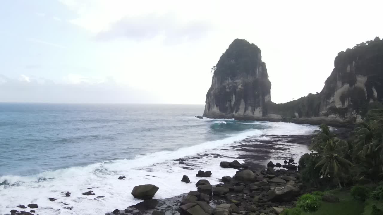 A beautiful view of Pangasan Beach in Pacitan, East Java, Indonesia. It features distinctive large coral reefs and terraced rice fields