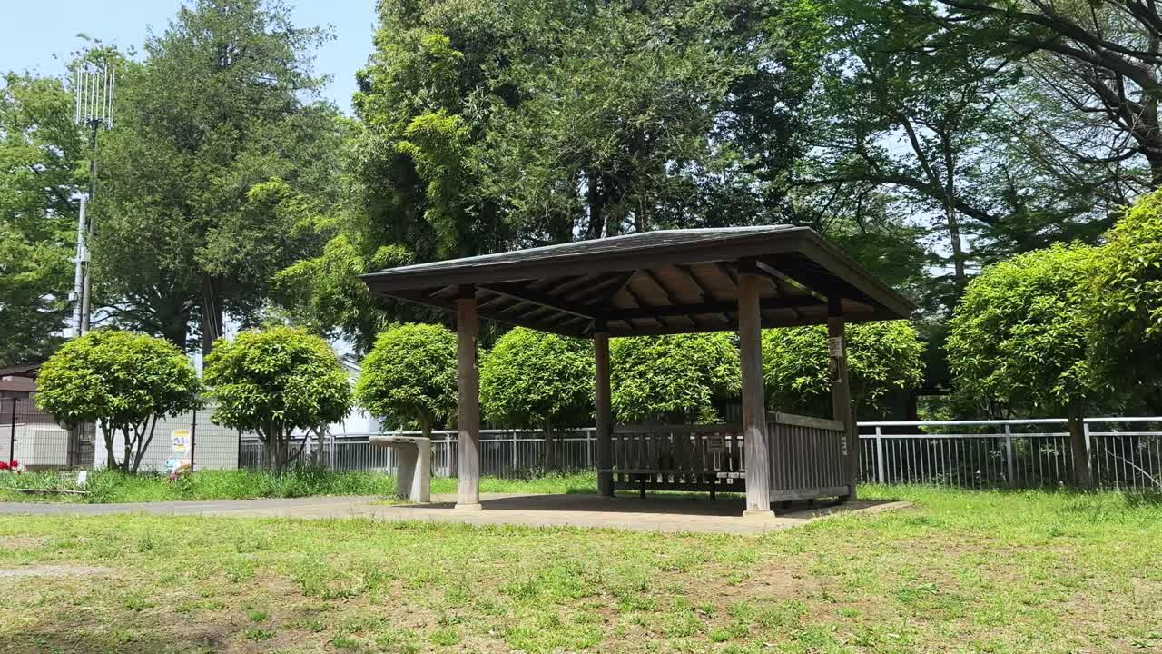 A peaceful view of a gazebo at Roka Kosyuen Park, Tokyo, Japan, on a sunny day