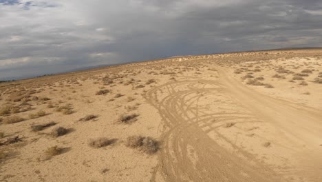 fast first-person low altitude flight over the parched plains of the mojave desert