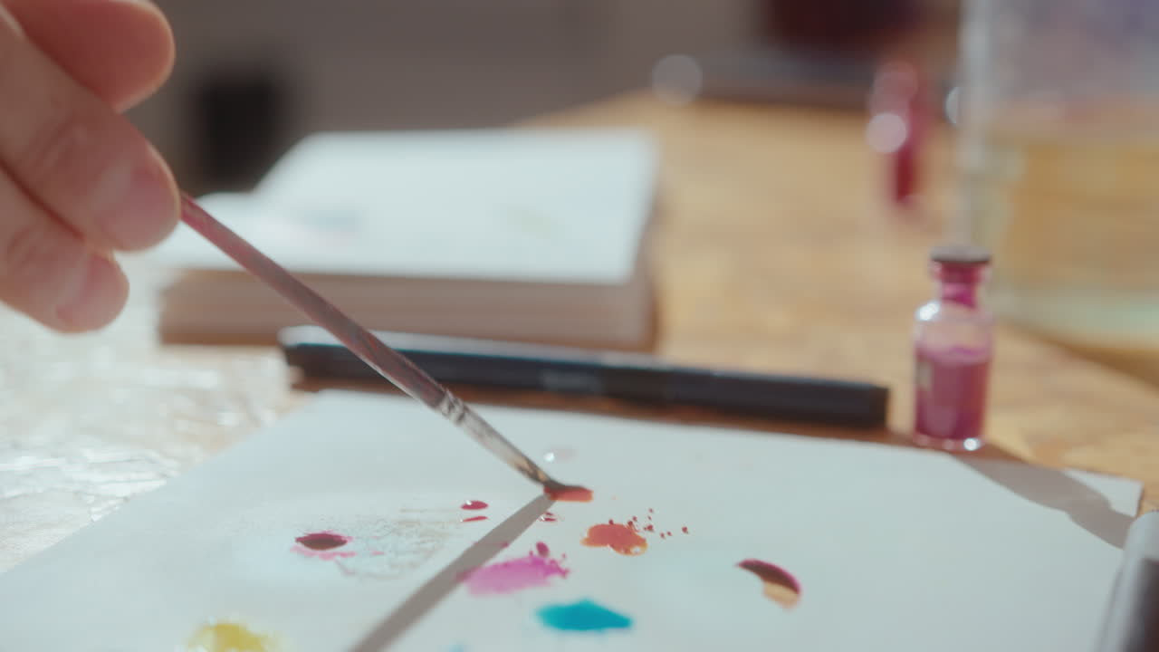 Artist Adding Water to Powdered Pigment before Painting