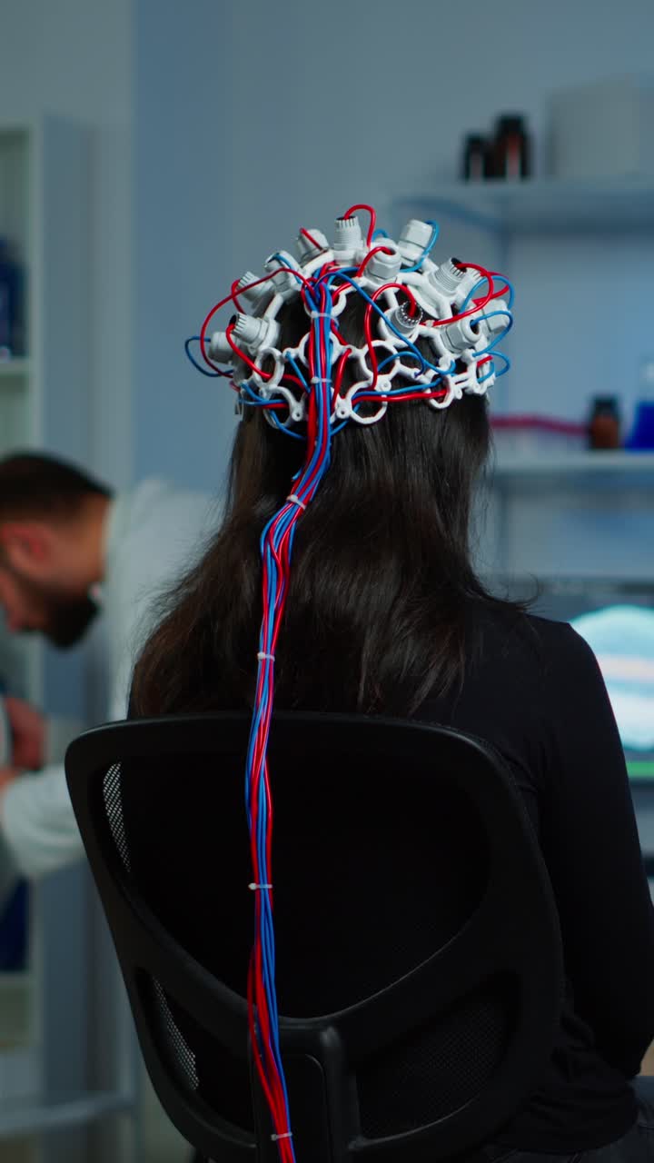 Woman undergoing an EEG brain scan in a research laboratory
