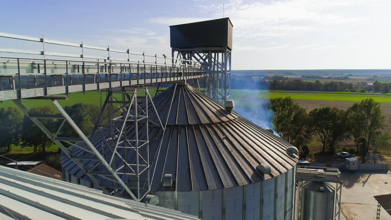 Grain warehouse, granary. Large steel towers for storing crops. Large animal feed factory. Aerial view.