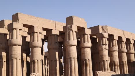 panning shot of the ancient columns of luxor temple in the center of the city