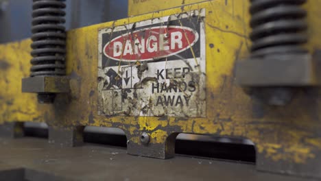 danger sign on a industrial fabricating sheer machine