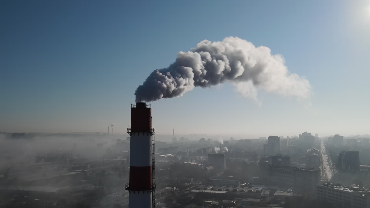 Aerial drone view of industrial smoke coming from pipe factory tube. City pollution idea