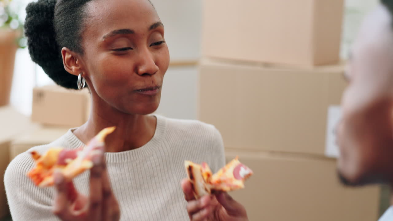 Couple, pizza and eating in new home
