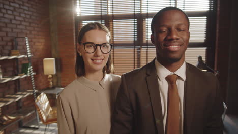 portrait of smiling multiethnic colleagues in office