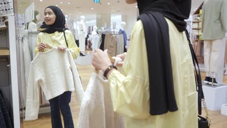 woman shopping for clothes in a clothing store