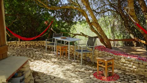 Outdoor-view-of-the-garden-terras-area-with-chairs-and-hammocks,-place-for-relaxing