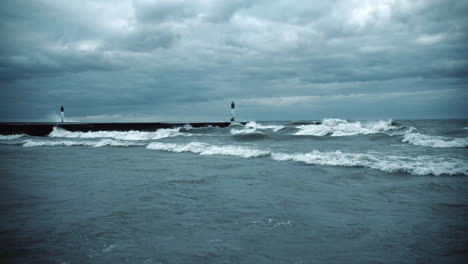 powerful storm surge waves crashing against pier wide shot