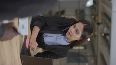 vertical shot of woman stressed on phone call