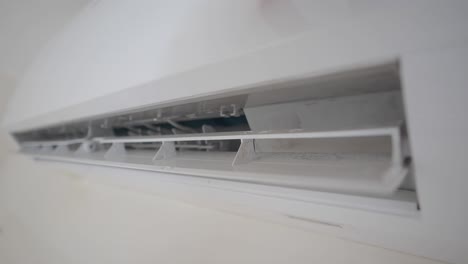 a close-up of a white wall-mounted air conditioner unit.