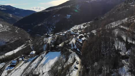 aerial: snowy mountain town on a mountain slope in the catalan pyrenees