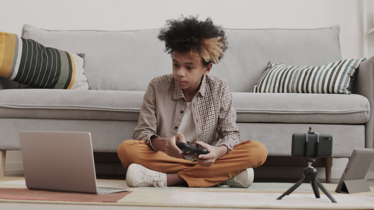 Teen playing video game on laptop