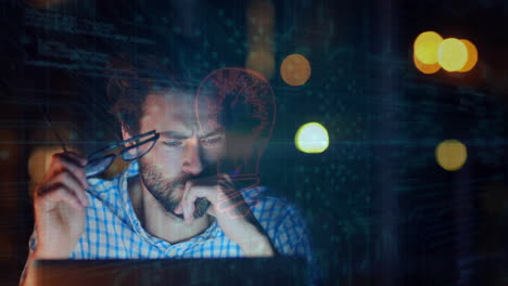 Holding glasses and looking at laptop, man with beard over animation of lightbulb