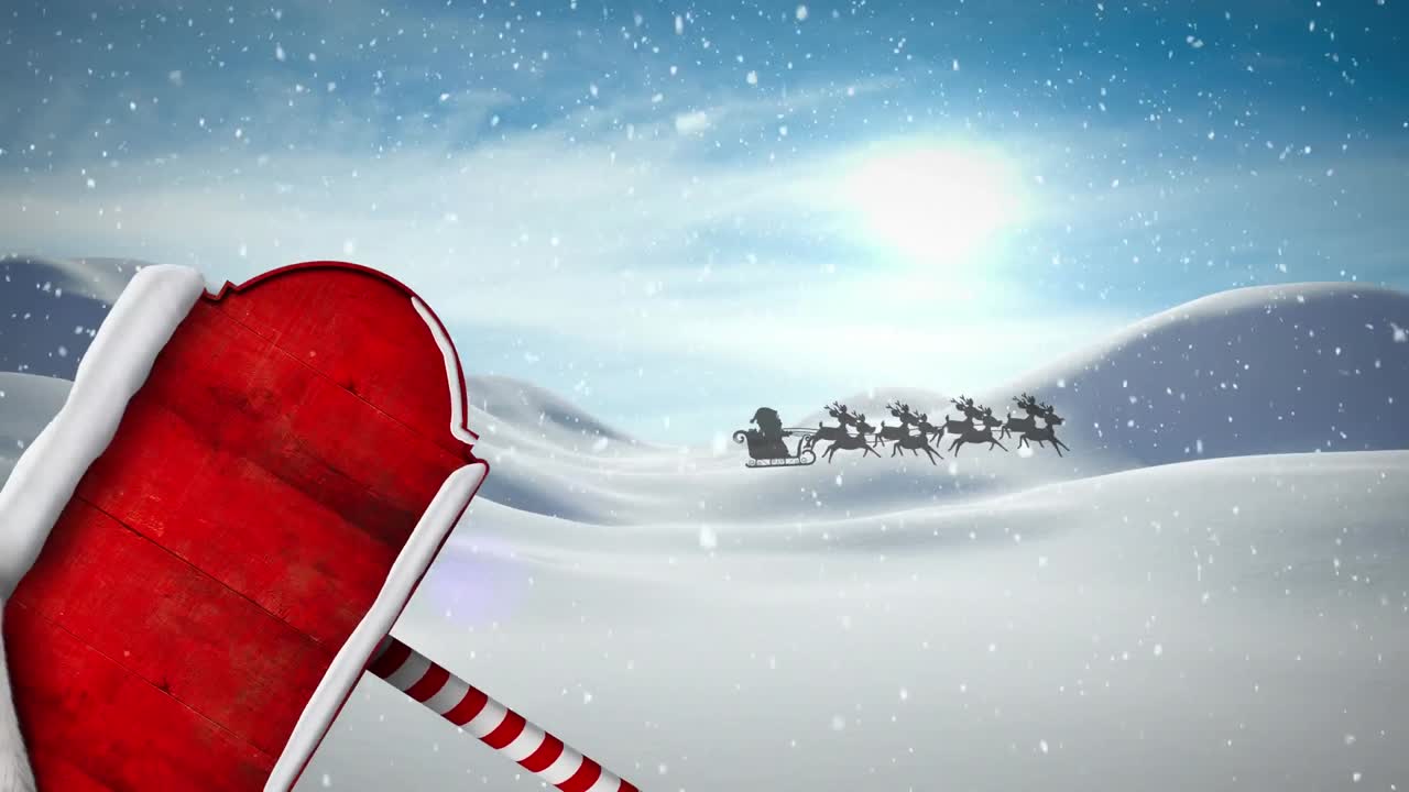 Animation of snow falling over santa hat over red signboard with copy space against winter landscape