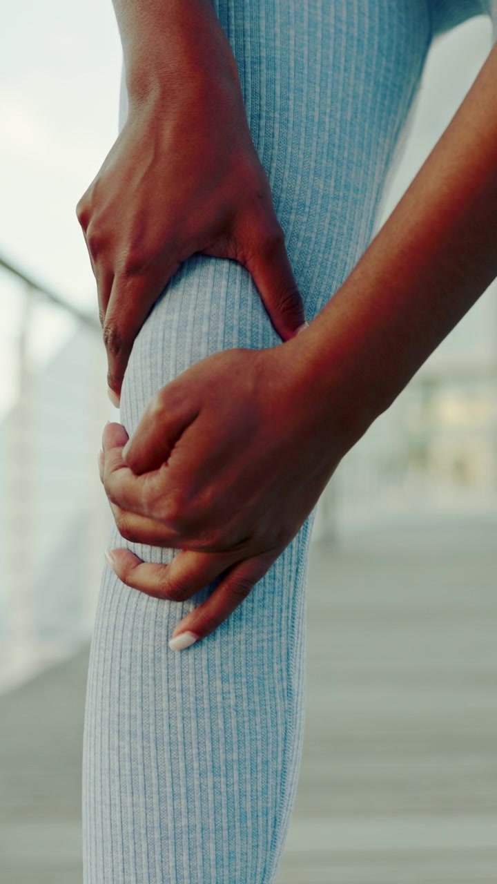 Athlete Massaging Sore Knee After Workout