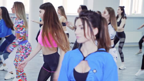 girls enjoying during fitness training. females having gymnastic exercises in fitness club