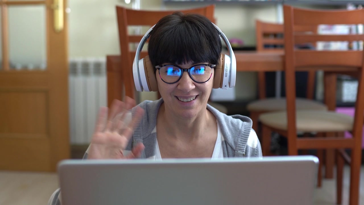 Woman talking by videoconference with laptop during quarantine by covid19