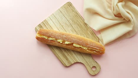 cream filled bread roll on wooden board