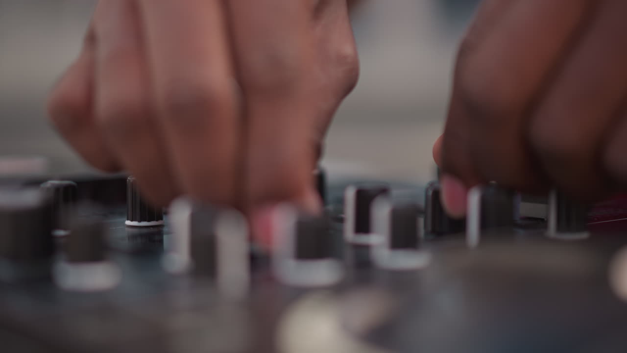 black DJ fingers adjusting audio mixer, street performer practicing scratch techniques, club soundcheck by live producer, rehearsal sampling and looping, closeup precision on faders and knobs