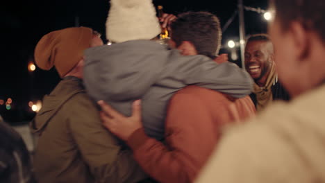 young group of multiracial friends having fun dancing playfully together enjoying rooftop party at night laughing celebrating friendship