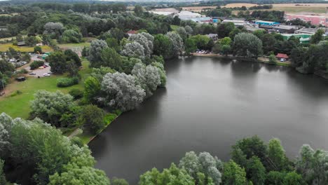 drone fly around needham market lake with beautiful view of the little traditional english village during a sunny day of summer