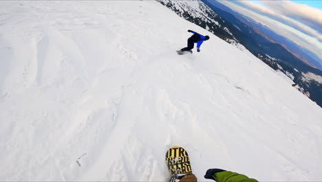 snowboarding in the beautiful mountains. first person's video of sportsman riding by the snowy slope.