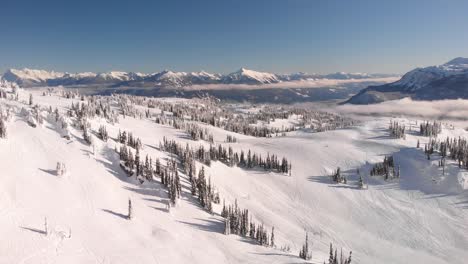 epic aerial view of the snowed mountains of revelstoke national park