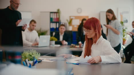 Worried-businesswoman-examining-documents-in-office.