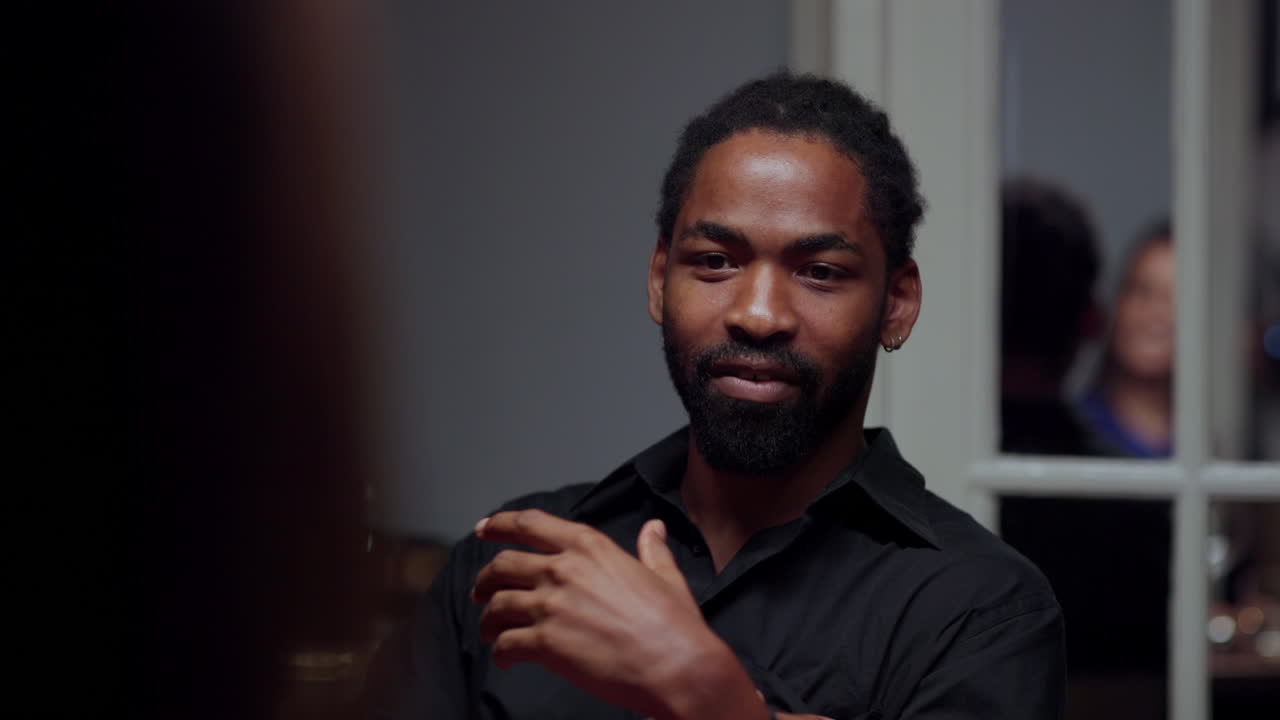 A man with a beard talking