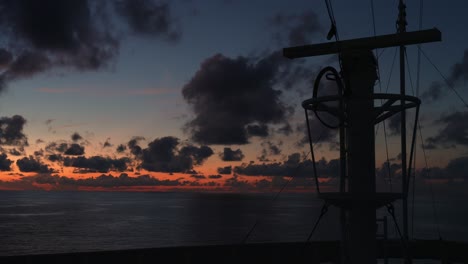 ocean voyage at dusk: front view of ship cruising through the ocean, capturing the stunning beauty of the sunset