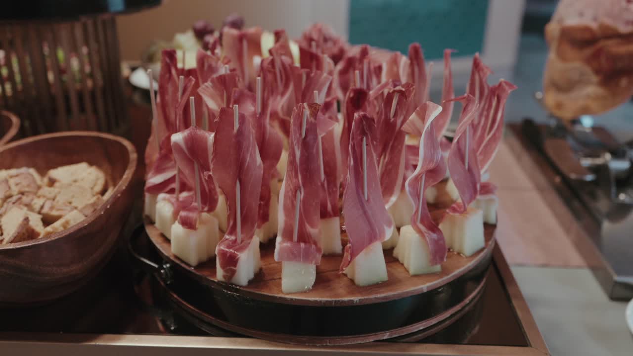 bite sized cheese cubes with prosciutto on skewers for elegant appetizer