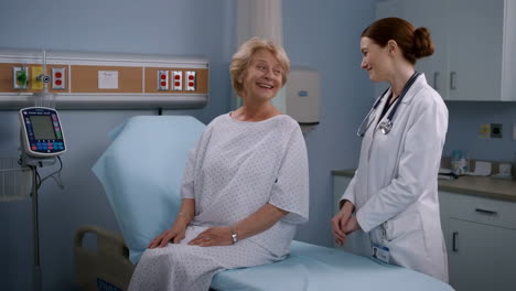doctor and patient smiling during a medical consultation in a hospital room
