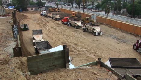 A-back-hoe-dumps-a-load-of-dirt-into-the-trailer-of-a-semi