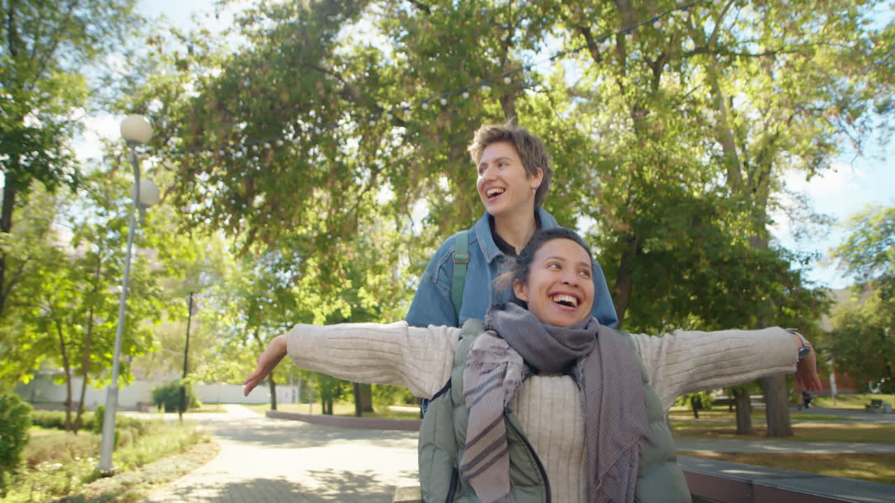 Two female friends having fun in a park