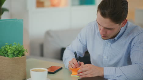 Entrepreneur Writes on Sticky Notes