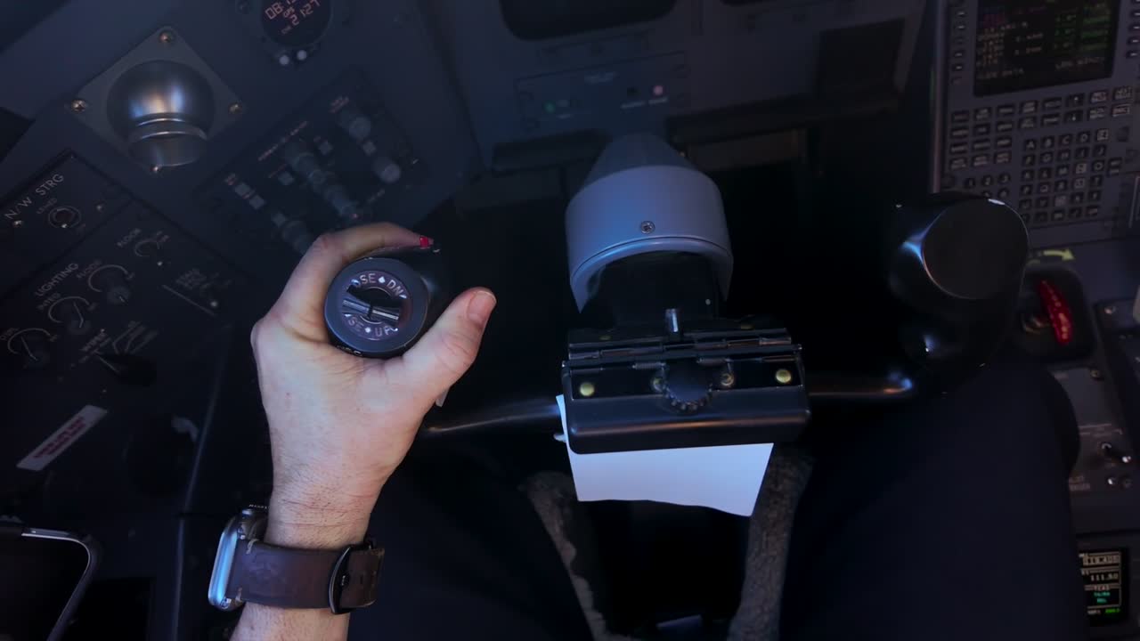 pilot’s eye view inside a modern jet cockpit while disconecting with the left hand the autopilot to take manual control of the airplane. High-angle shot