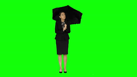 Businesswoman-wearing-umbrella-on-green-screen-