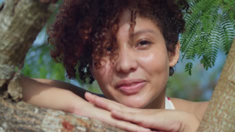 young red hair girl close up while smiling in a park