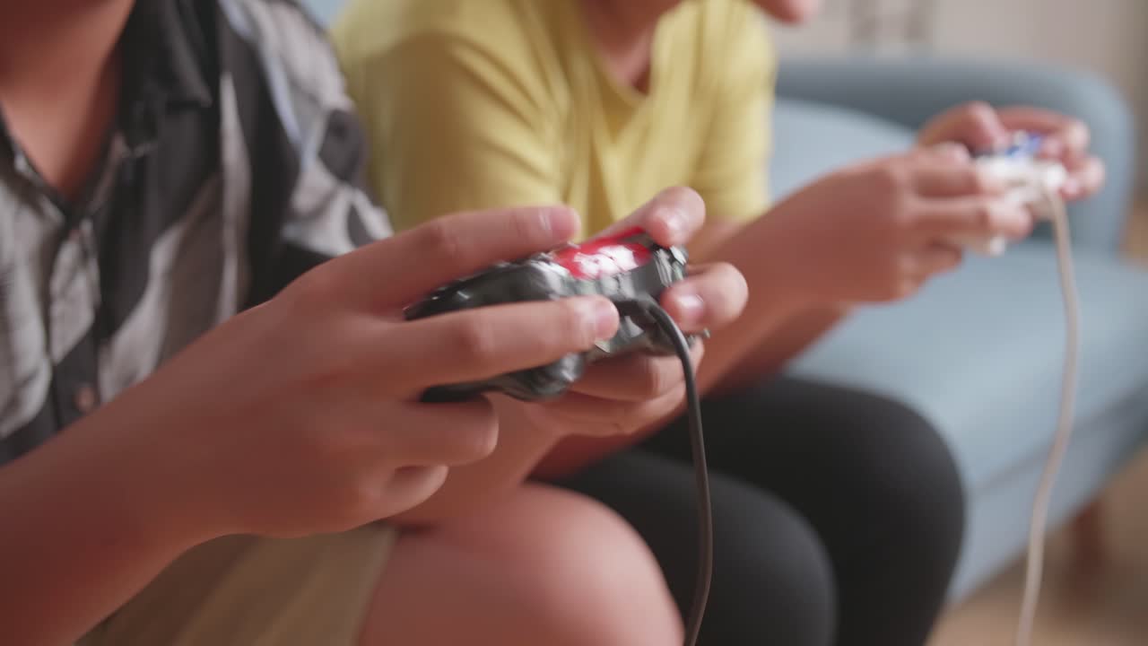 Close Up Children'S Hands Holding Joystick Game Play Video Game At Home